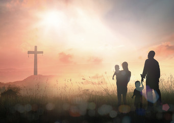 Ascension day concept: Silhouette people looking for the cross on autumn sunrise background