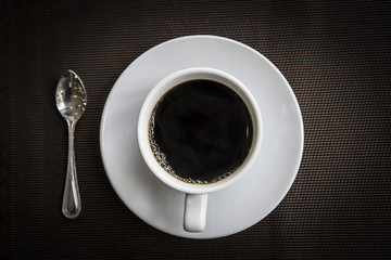 Obraz na płótnie Canvas cup of fresh espresso on black table view from above