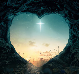 Good Friday concept: The cross of star with heart shape of empty tomb stone on night background