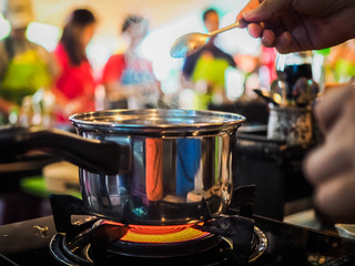 Fototapeta na wymiar closeup of a pot on gas stove during a thai cooking class