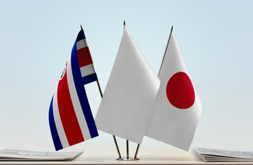 Flags of Costa Rica and Japan with a white flag in the middle