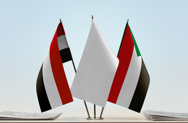 Flags of Yemen and Sudan with a white flag in the middle