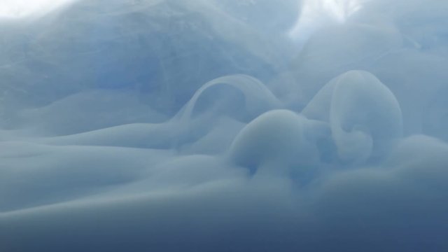 Cloud of ink floating slowly in water
