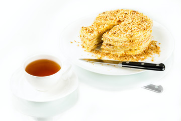 cup of tea, puff homemade cake with custard and biscuit crumb