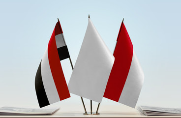 Flags of Yemen and Monaco with a white flag in the middle