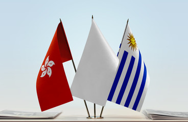 Flags of Hong Kong and Uruguay with a white flag in the middle