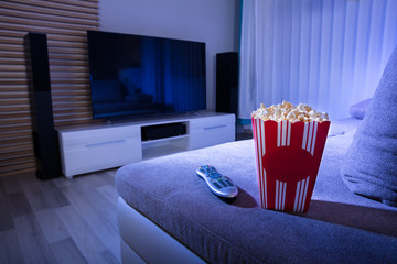 Close-up Of Popcorn And Remote Control On Couch