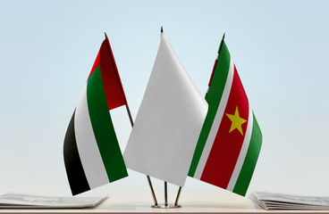 Flags of UAE and Suriname with a white flag in the middle