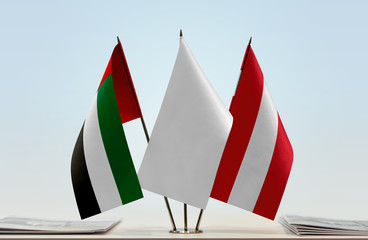 Flags of UAE and Austria with a white flag in the middle