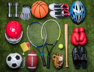 Zelfklevend Fotobehang Various Sport Equipments On Grass © Andrey Popov