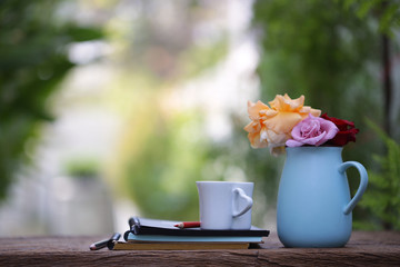 Colorful Roses in blue pot with notebook