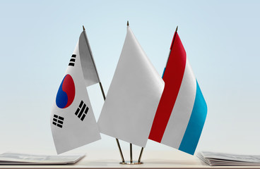 Flags of South Korea and Luxembourg with a white flag in the middle