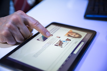 Fototapeta premium Businessperson Using Social Networking Site On Digital Tablet
