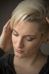 Head and shoulders portrait of young woman in windor light.