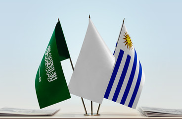 Flags of Saudi Arabia and Uruguay with a white flag in the middle