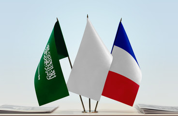Flags of Saudi Arabia and France with a white flag in the middle