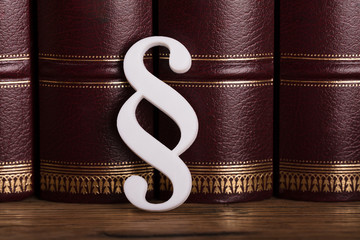 Paragraph Symbol Leaning On Law Books