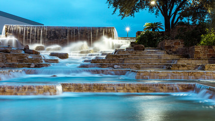 Urban water fountain with lights/water flowing over steps and rocks © Moab Republic