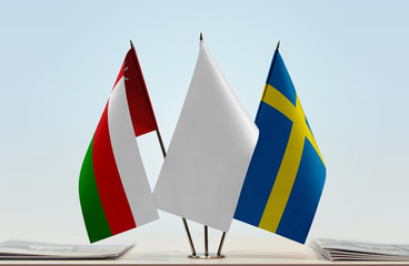 Flags of Oman and Sweden with a white flag in the middle