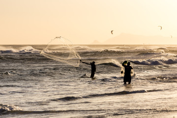 Fishermen at work during sunset