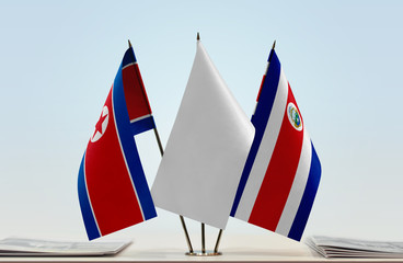 Flags of North Korea and Costa Rica with a white flag in the middle