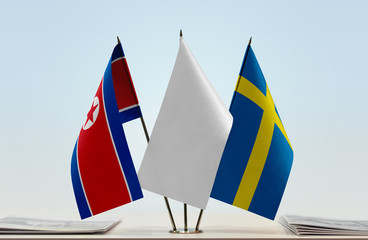 Flags of North Korea and Sweden with a white flag in the middle