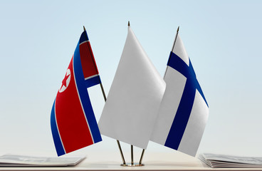 Flags of North Korea and Finland with a white flag in the middle