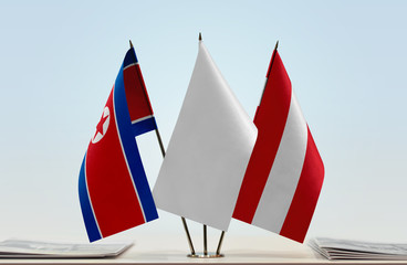 Flags of North Korea and Austria with a white flag in the middle