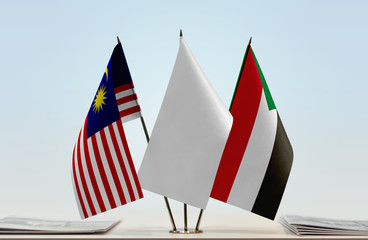 Flags of Malaysia and Sudan with a white flag in the middle