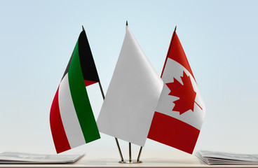 Flags of Kuwait and Canada with a white flag in the middle