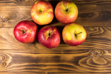 Red apples on wooden table. Top view, copy space