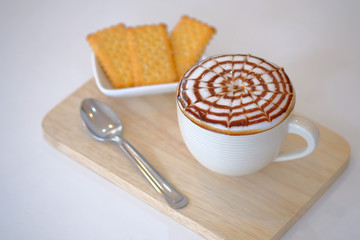 Hot coffee decorated with caramel macchiato served , Macchiato coffee, Latte art, Hot beverage with caramel syrup,