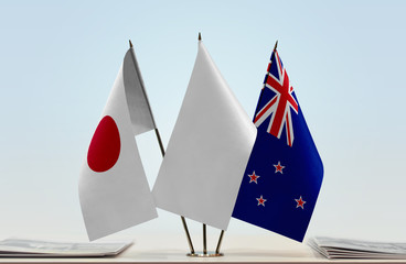 Flags of Japan and New Zealand with a white flag in the middle