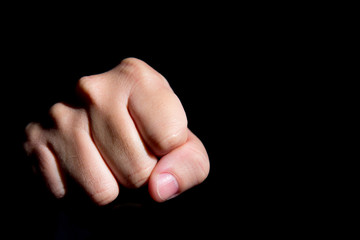 Hand punch fist on a black background