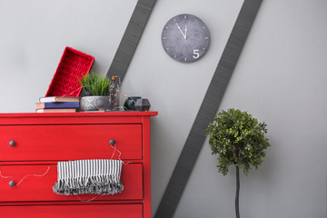 Cozy wardrobe room interior with red chest of drawers