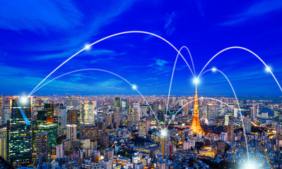 Business concept for information, communication , connection technology - panoramic modern city skyline, bird eye aerial night view under beautiful dark blue night sky in Roppongi Hill, Tokyo, Japan.