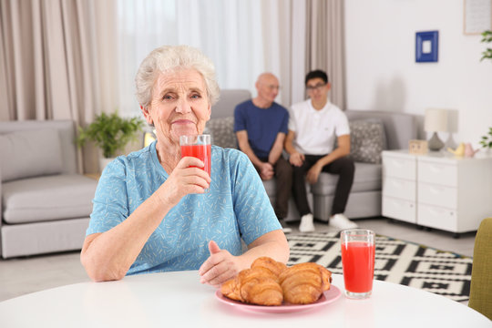 Senior woman having breakfast at home. Elderly care