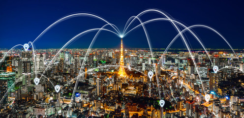 Business concept for information, communication , connection technology - panoramic modern city skyline, bird eye aerial night view under beautiful dark blue night sky in Roppongi Hill, Tokyo, Japan.