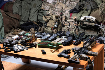 A lot of rifles, guns, grenades, helmets, gas masks, ammunition, vests, devices and other military gear.