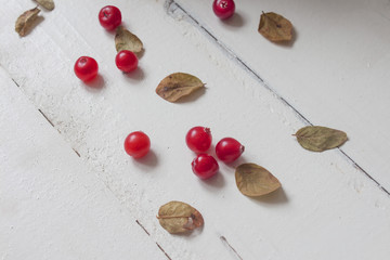 a little scattered fresh red healthy cranberries on the table from above