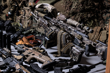 Fototapeta premium A lot of rifles, guns, grenades, helmets, gas masks, ammunition, vests, devices and other military gear.