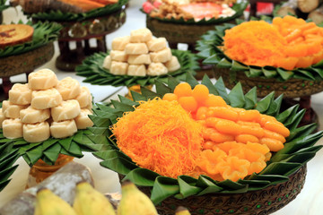 Thai sweetmeat appetizer made from egg and sugar in leaf basket set for sacrificial offering in Thai traditional celebration.