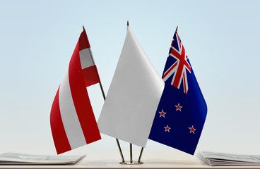Flags of Austria and New Zealand with a white flag in the middle