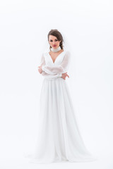 Fototapeta na wymiar brunette bride posing in elegant wedding dress, isolated on white