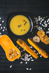 Pumpkin soup on a dark wooden background