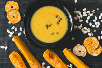 Pumpkin soup on a dark wooden background