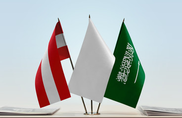 Flags of Austria and Saudi Arabia with a white flag in the middle