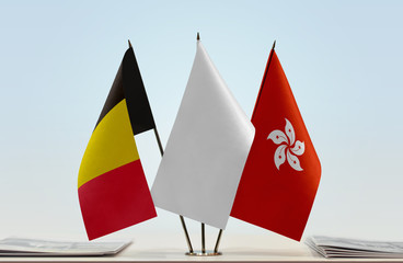 Flags of Belgium and Hong Kong with a white flag in the middle