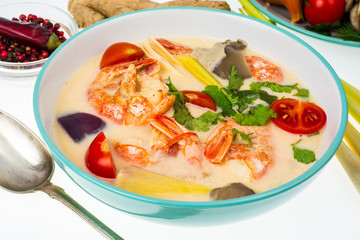 Popular Thai Tom yam soup with prawns and vegetables on white background