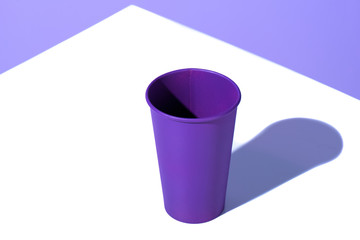 purple plastic disposable cup, on white surface